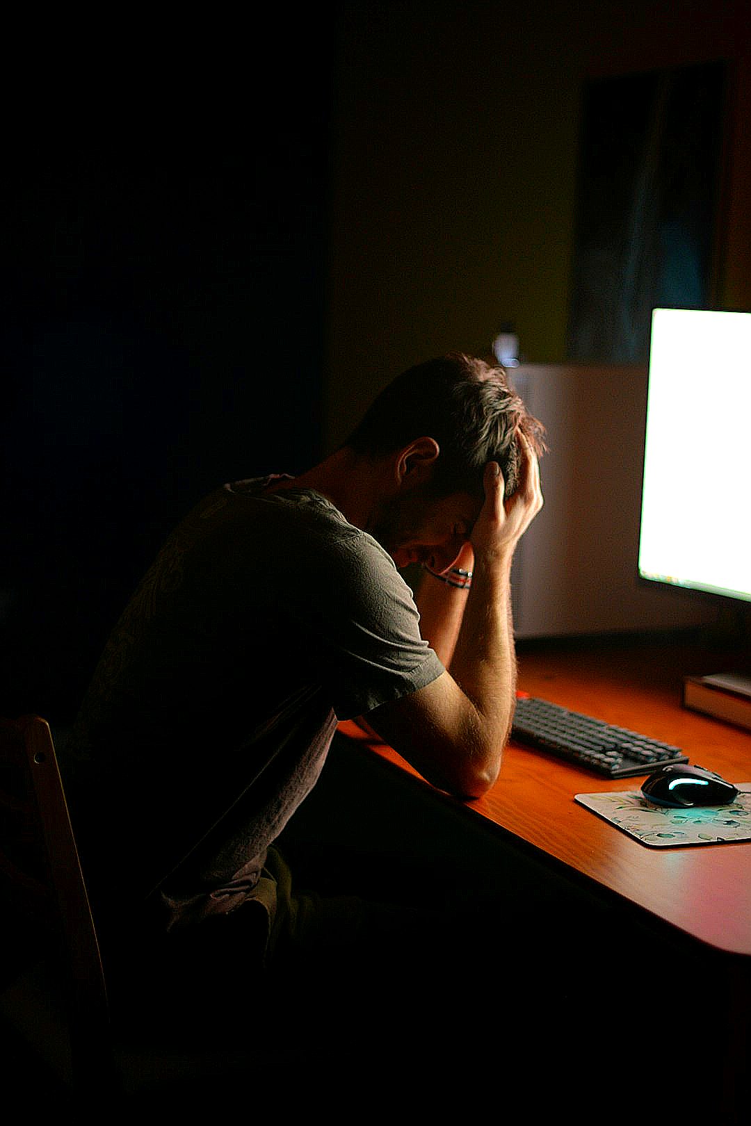 a man sitting at a desk in front of a computer