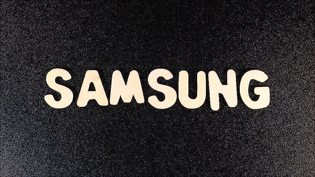 a close up of a samsung logo on a black surface