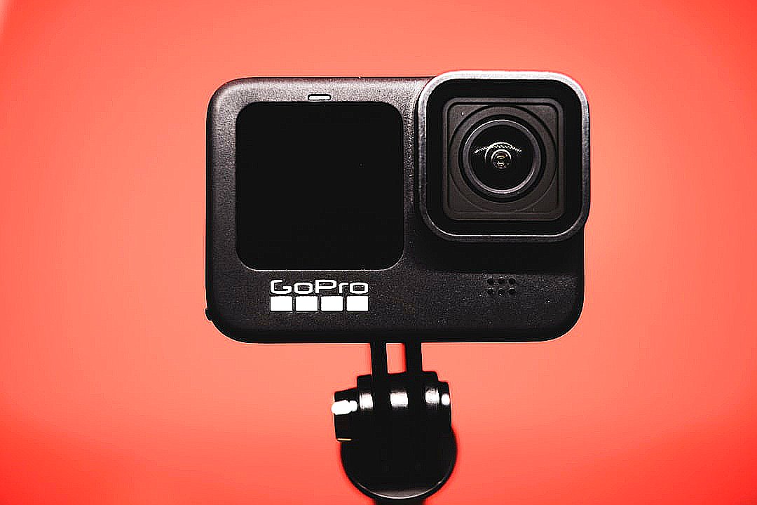 black and silver camera on orange surface
