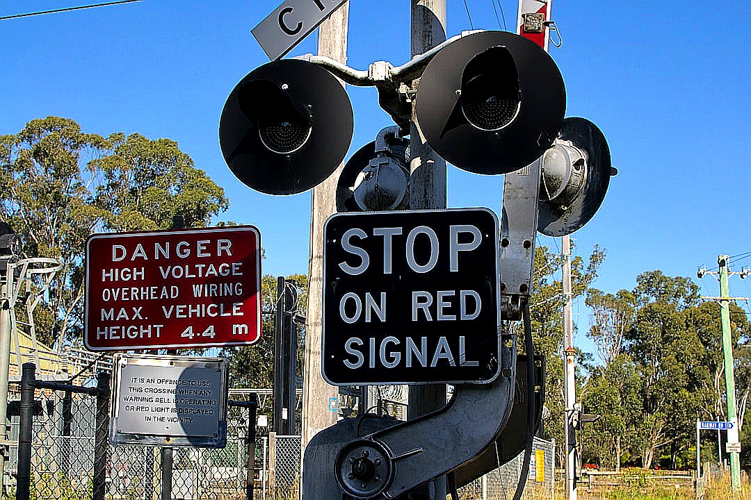 Railroad crossing signal with warning signs.