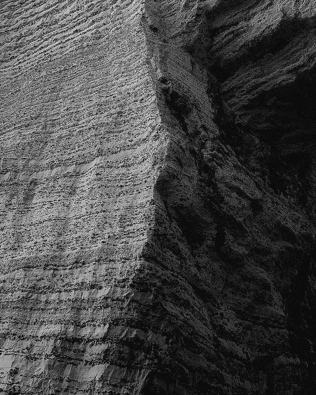 A textured rock face in contrasting light.