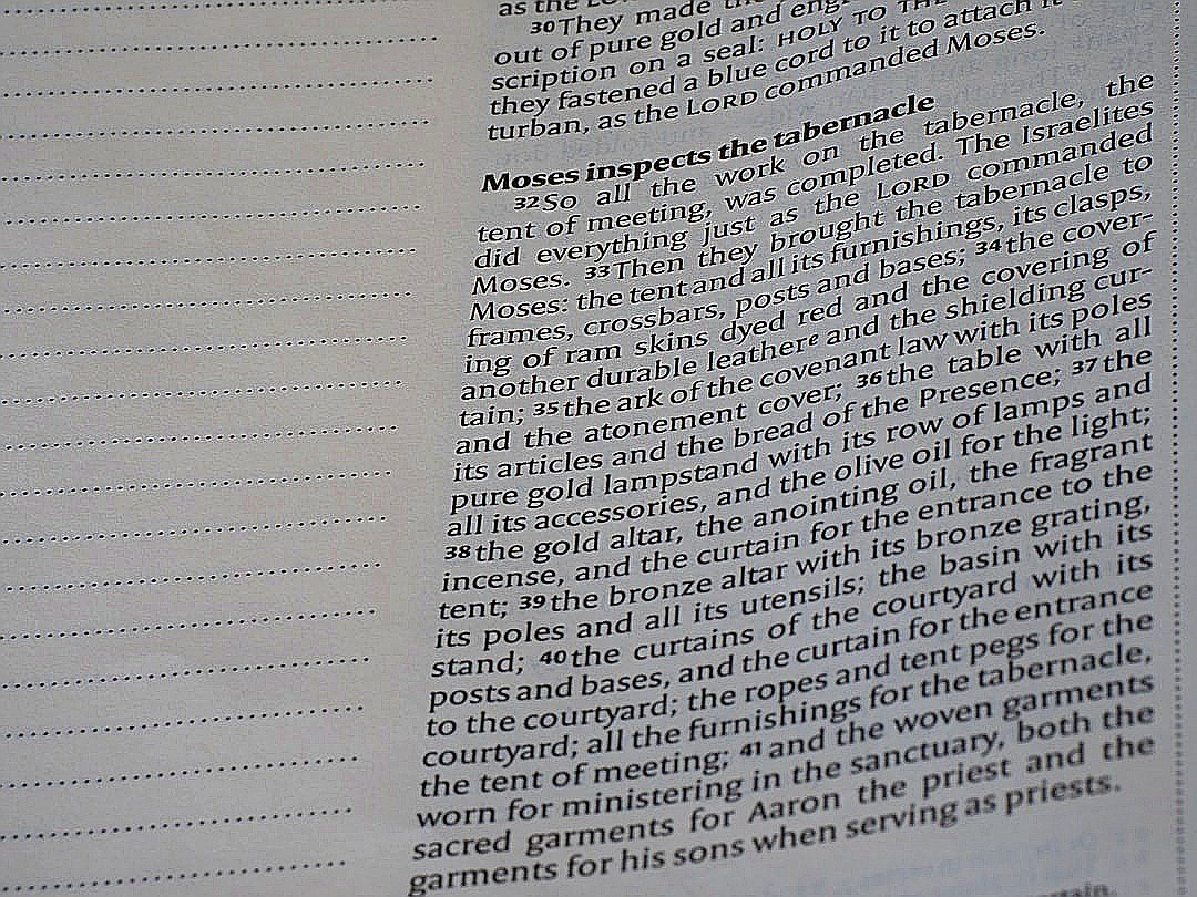 Close-up of text in a book with a faint watermark.