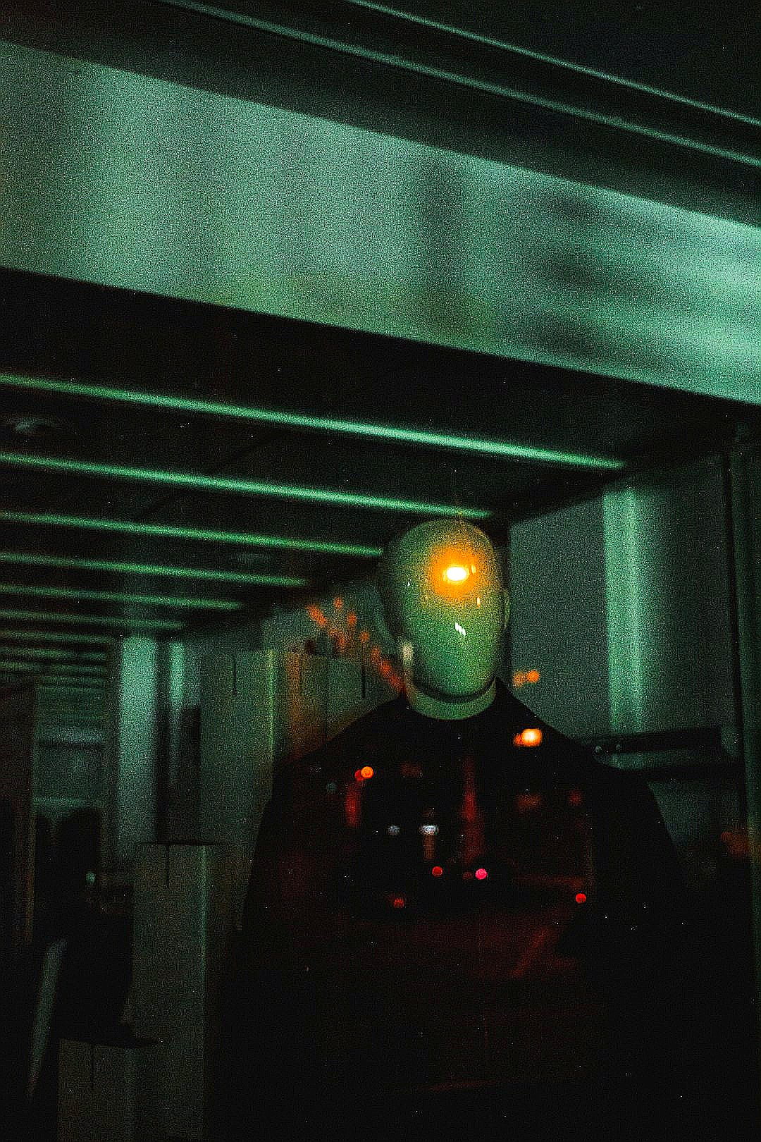 a man in a dark room with a yellow light on his face