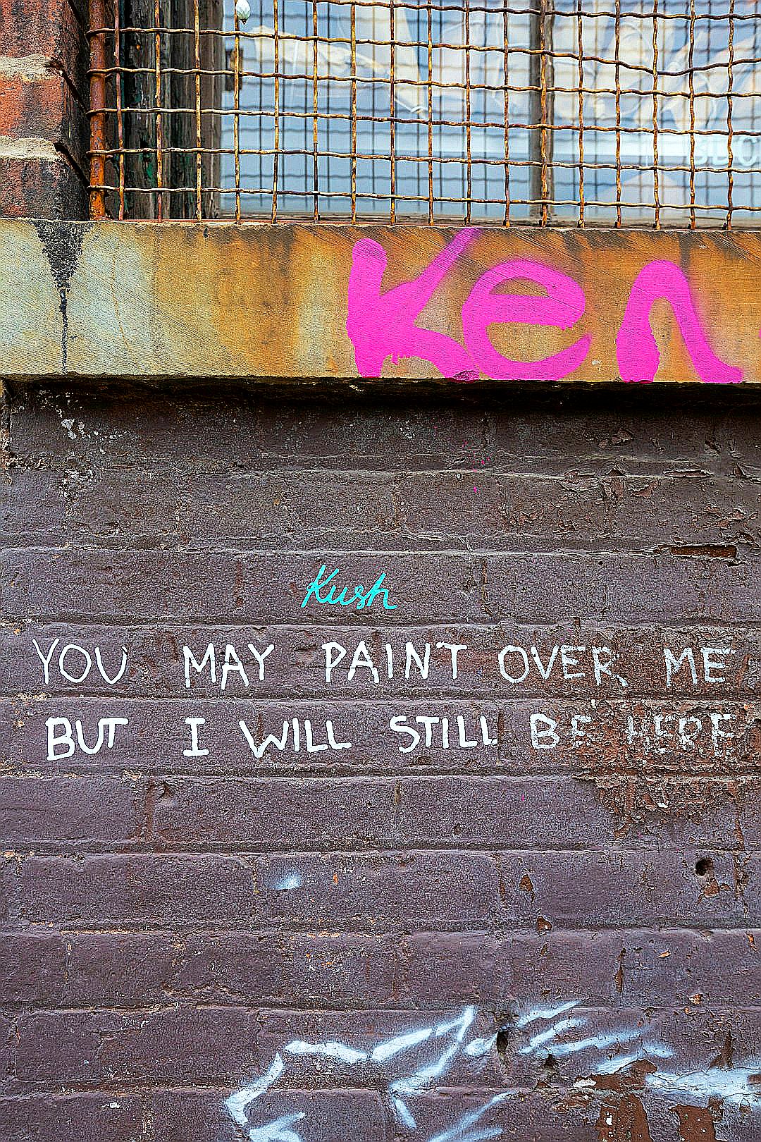 Graffiti on a brick wall with a message