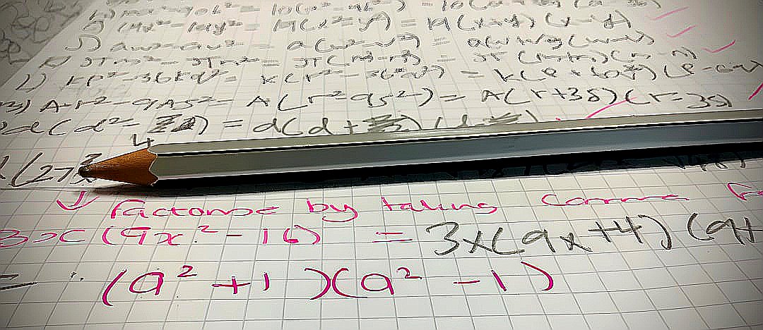 A pencil sitting on top of a piece of paper