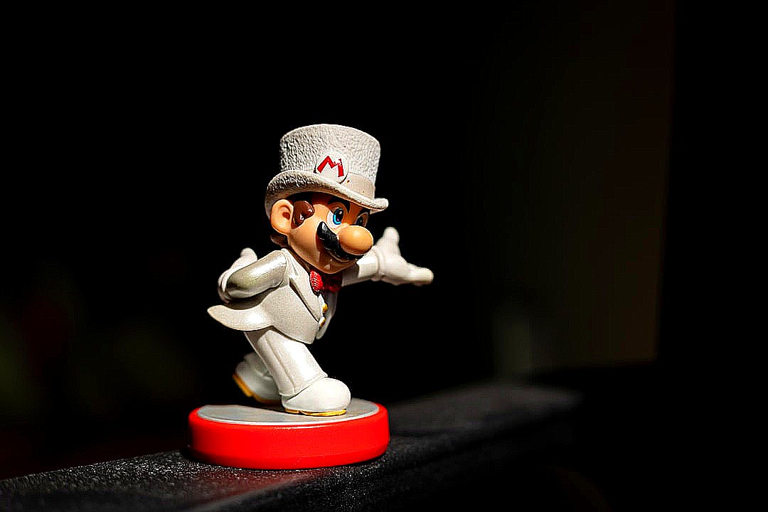 a toy figurine of a person wearing a hat and holding a gun