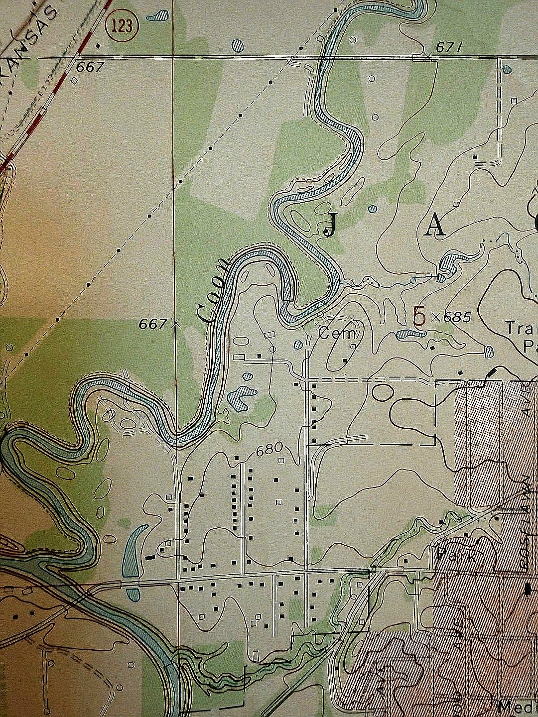 Topographic map showing a winding river and contour lines.