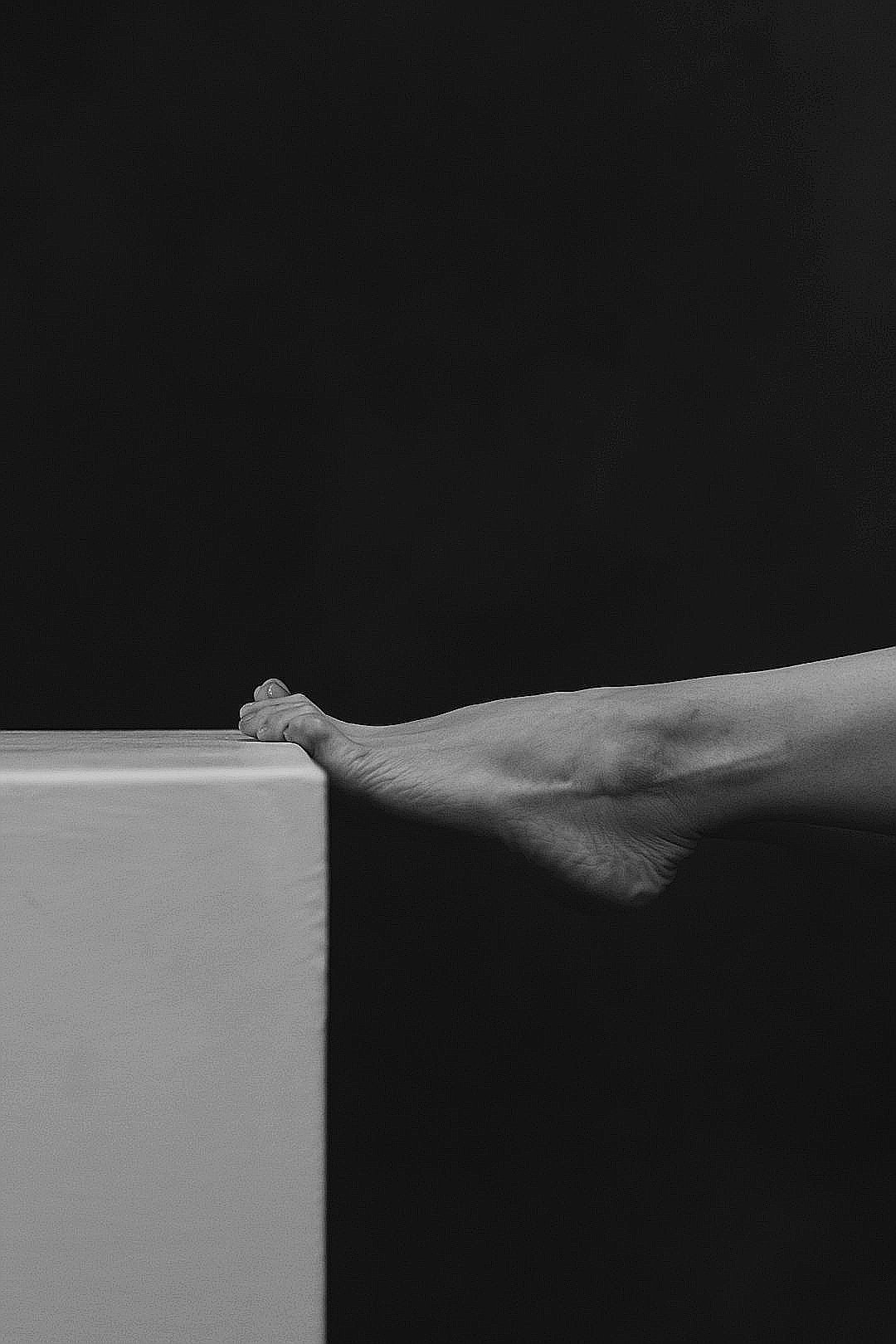 a hand holding a white object