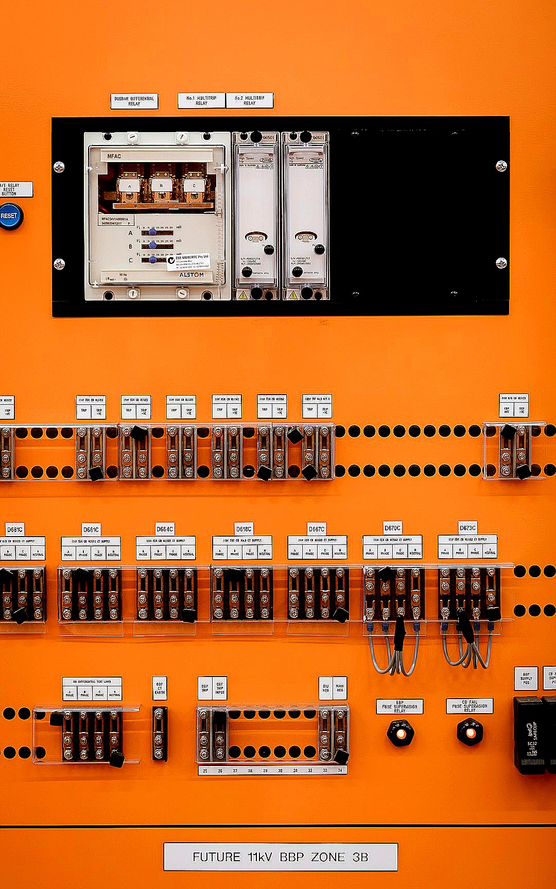 Control panel with electrical components is shown