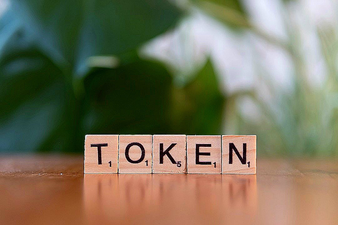 A wooden block that says token sitting on a table