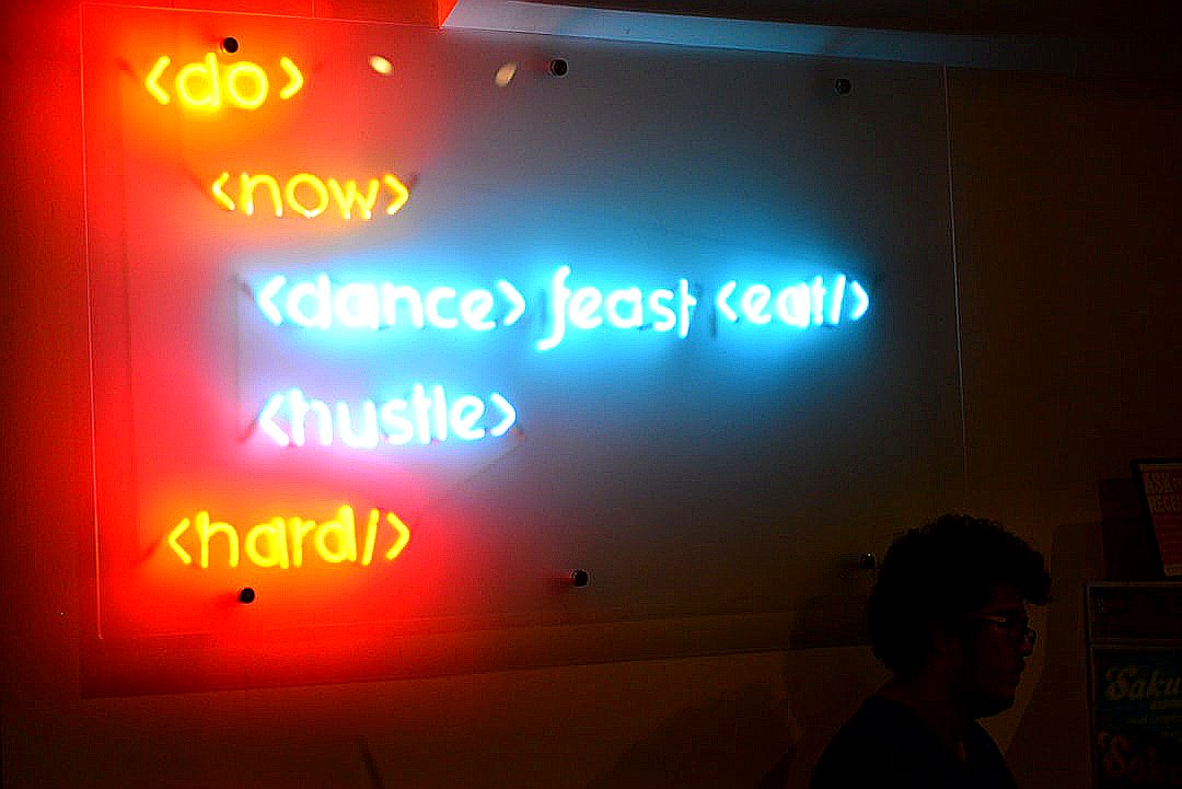 a person standing in front of a screen with text