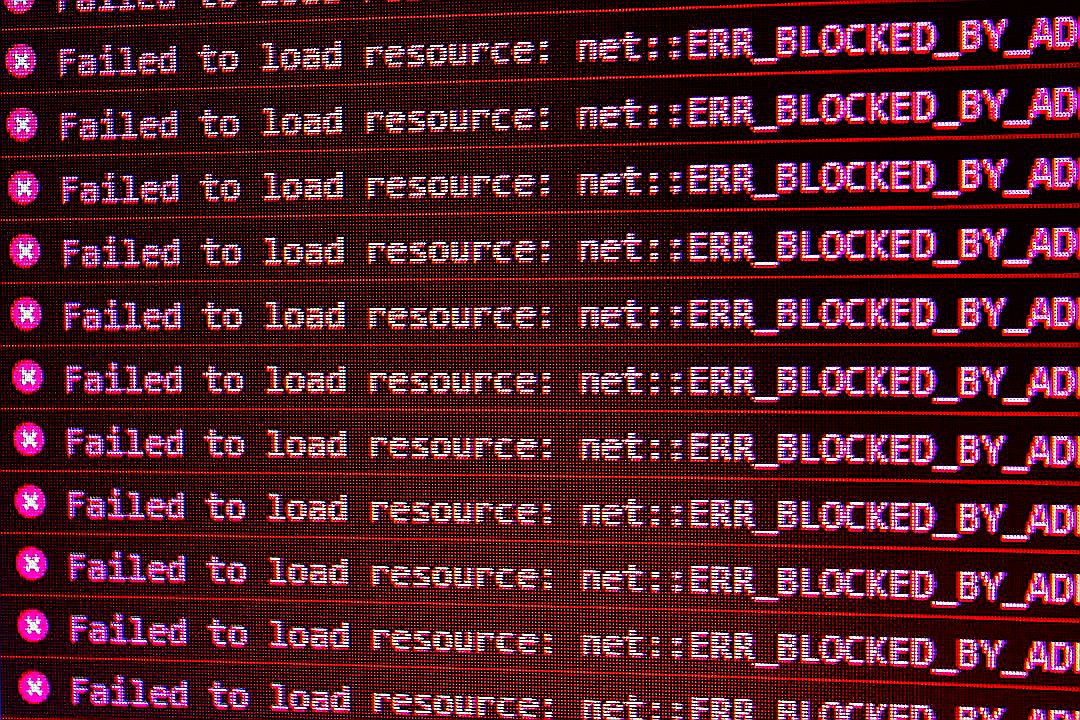 Red error messages on a black computer screen indicating blocked web resources