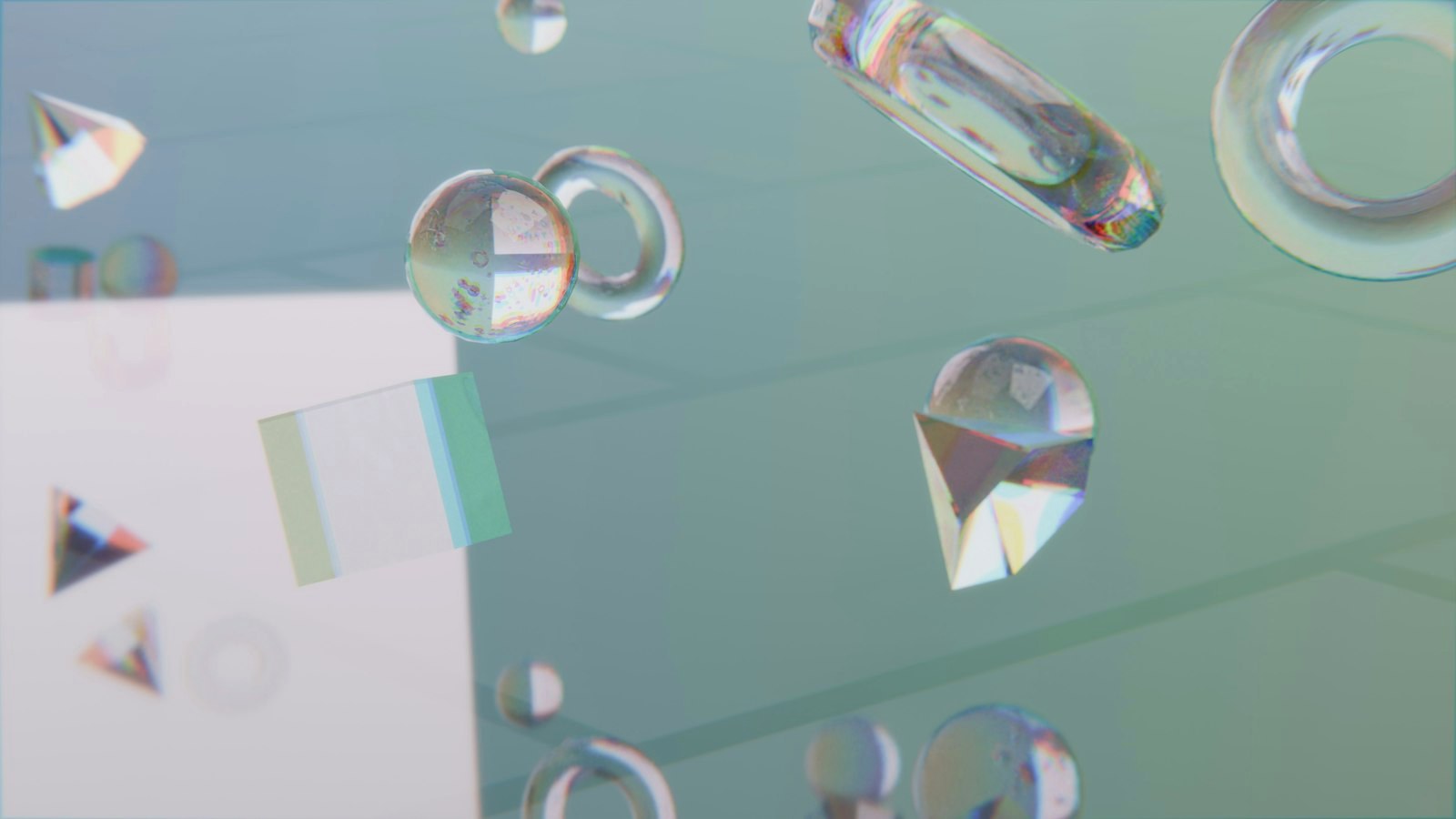 Clear geometric shapes floating against a light blue-green background