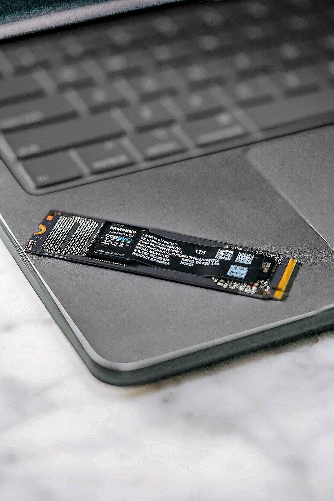 A close up of a laptop keyboard with a stick on it
