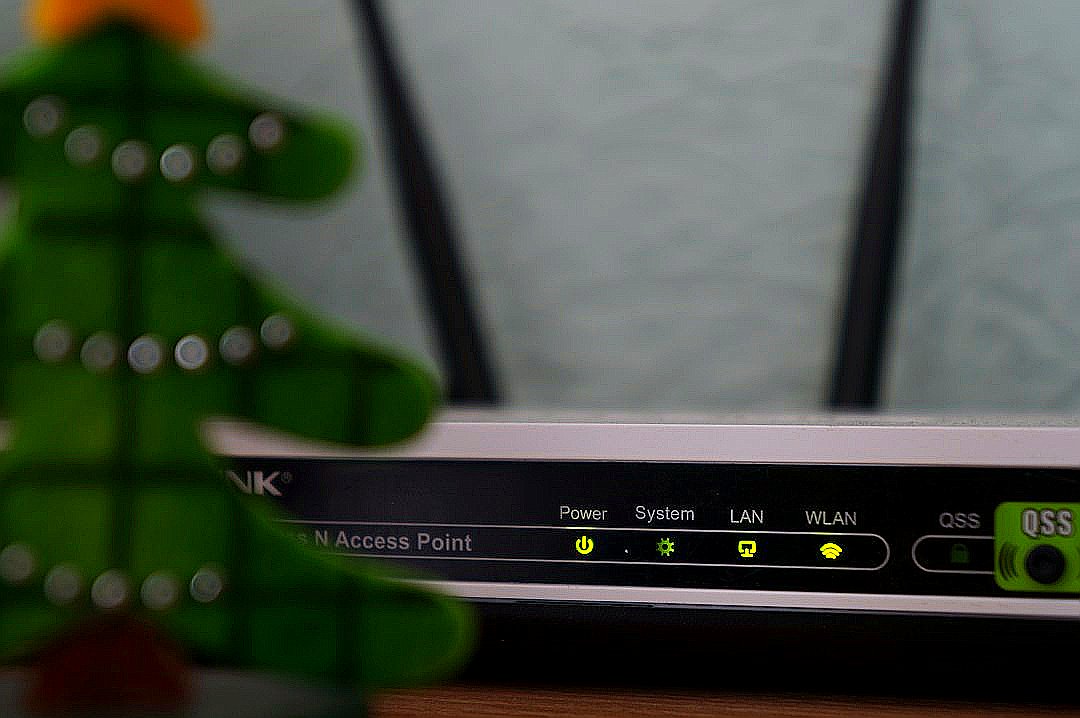 white and black modem router with four lights