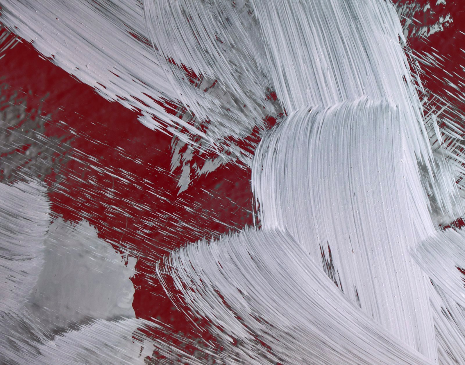 A red and white painting with white paint streaks