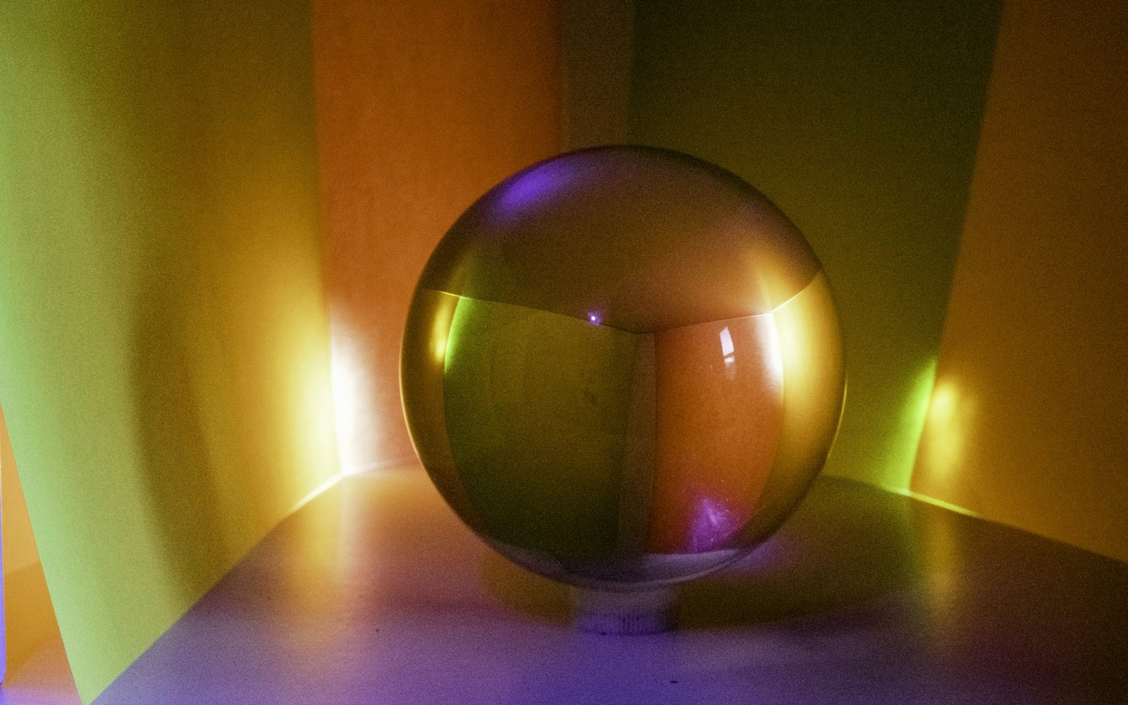 A reflective sphere in a colorful, abstract setting