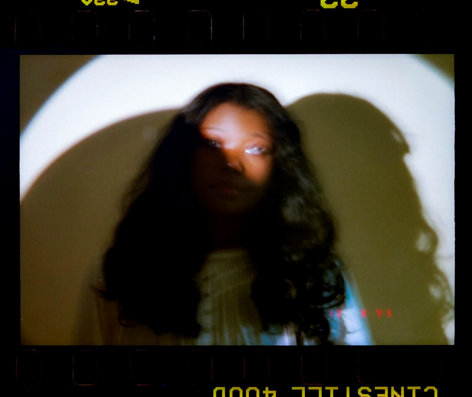 Young woman with long dark hair in dramatic lighting