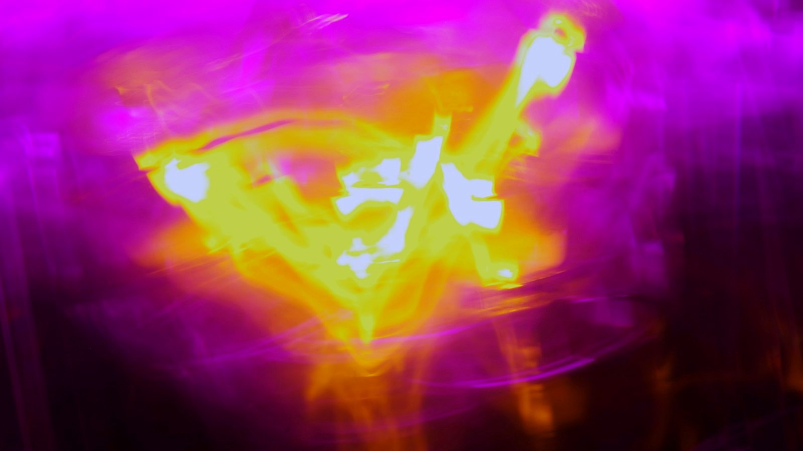 A blurry image of a yellow and purple object