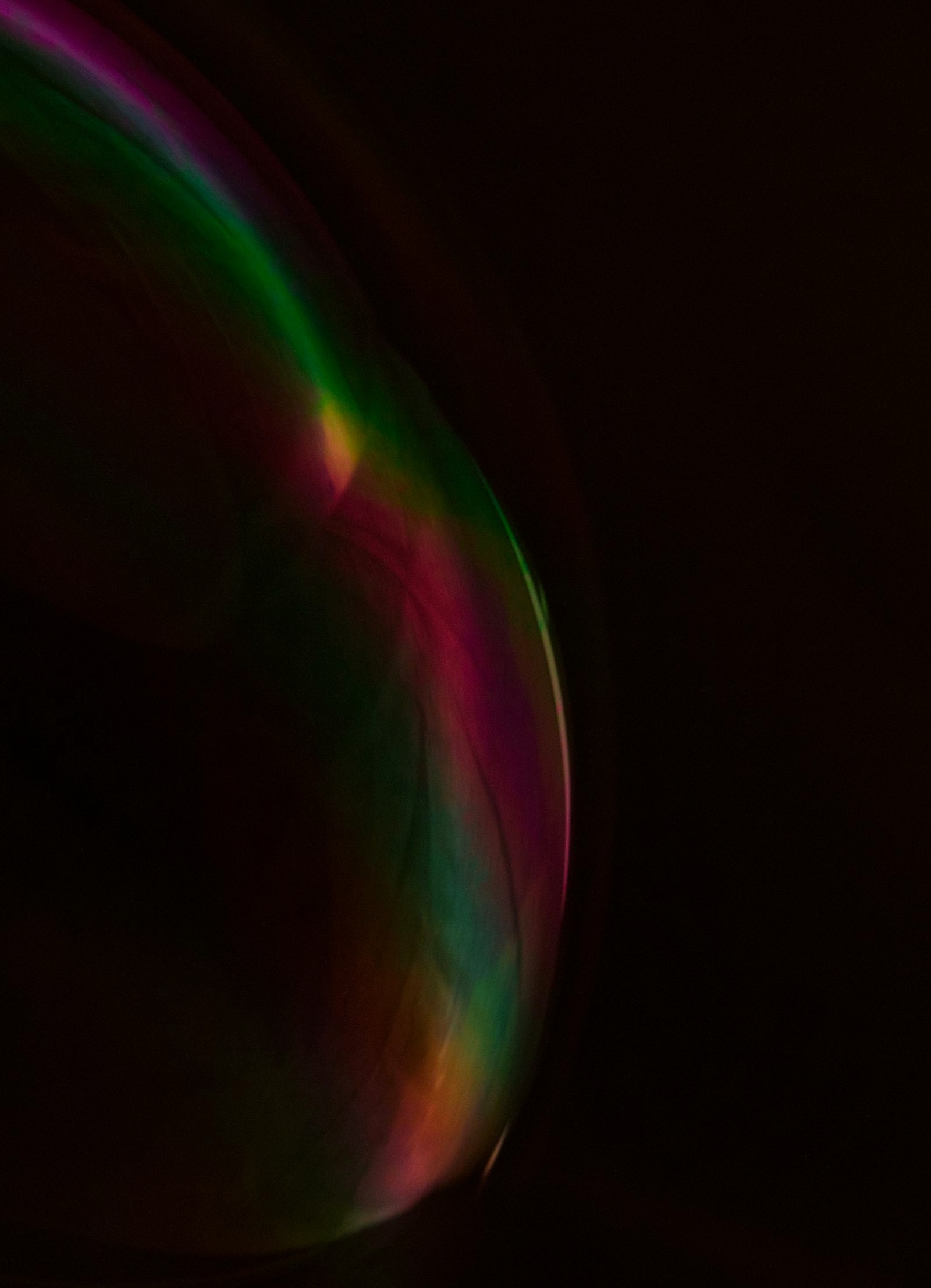 Close-up of a colorful bubble against black background