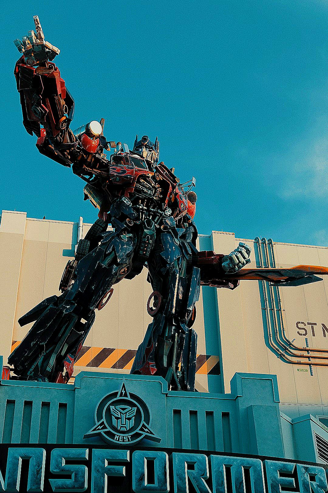 a giant statue of a transformer standing on top of a building